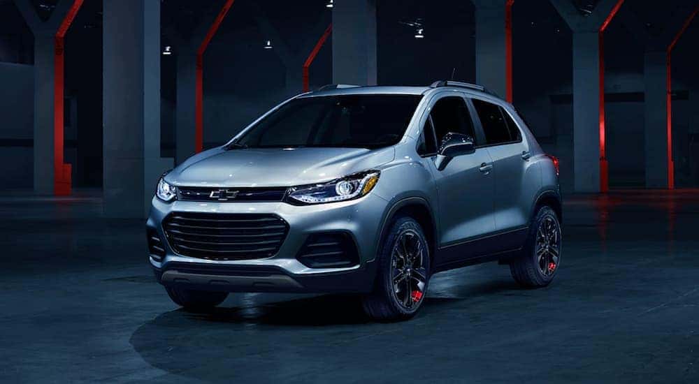 A popular used Chevy Trax for sale, a silver 2020 Chevy Trax, is shown parked at night.