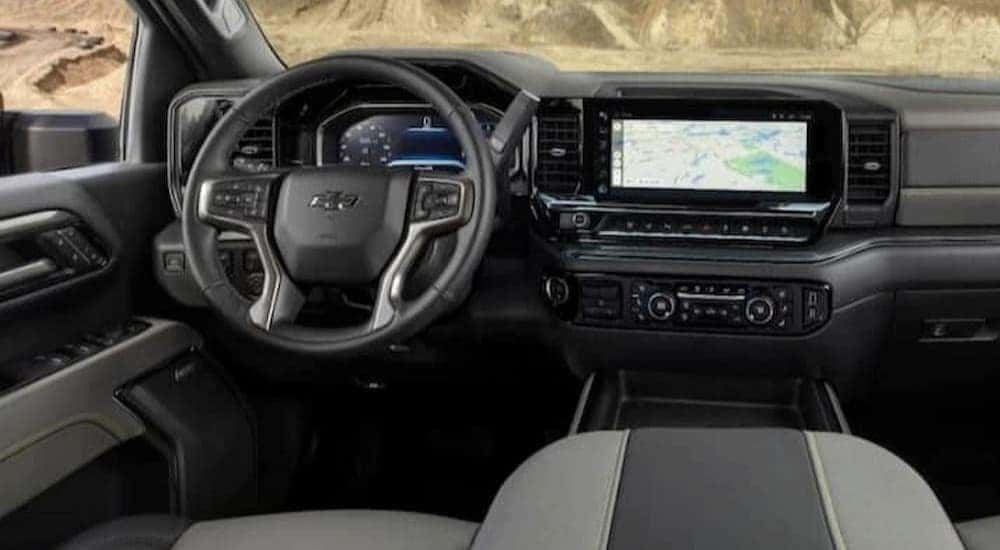 The black and gray interior and dash in a 2024 Chevy Silverado 1500 ZR2 is shown.