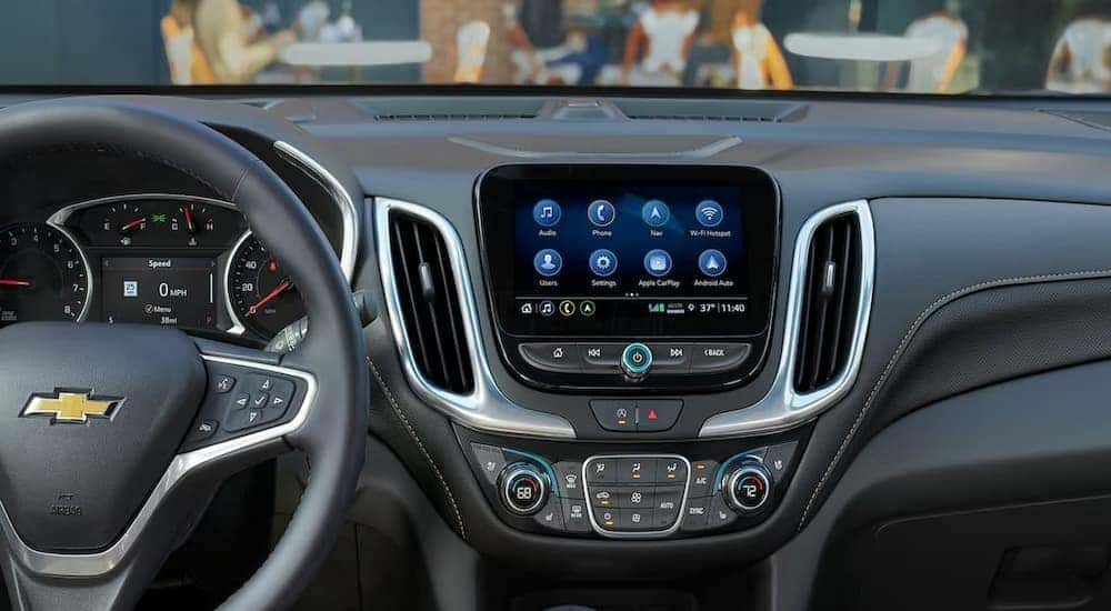 The black interior and dash of a 2024 Chevy Equinox Premium is shown.