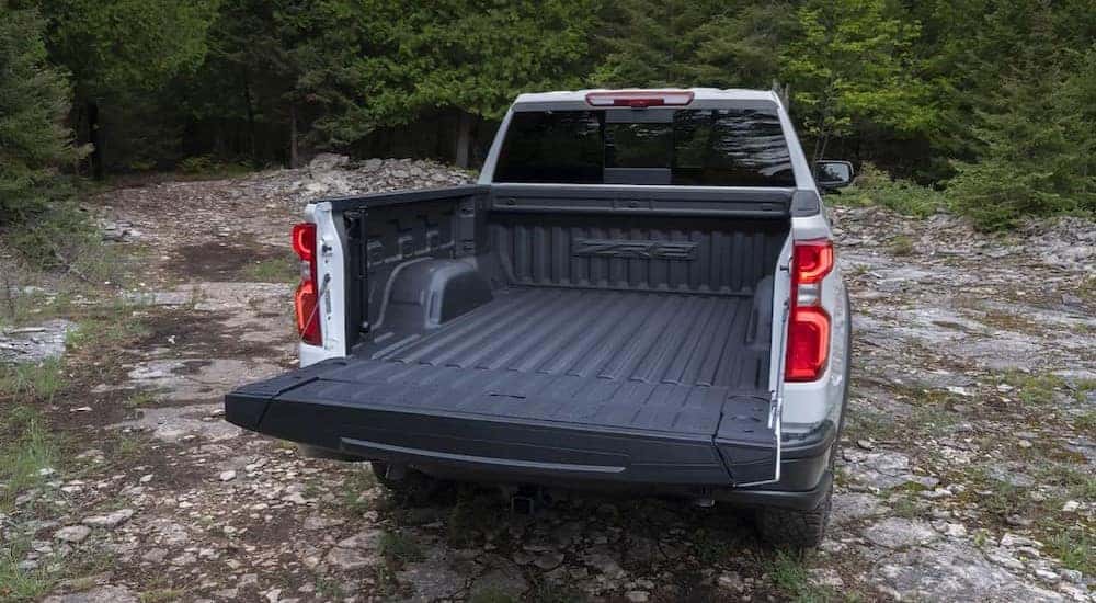 A rear view of a white 2024 Chevy Silverado 1500 ZR2 with an open tailgate.
