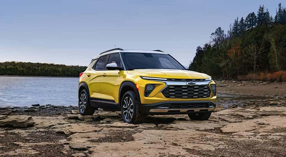 A yellow 2024 Chevy Trailblazer ACTIV parked on a beach.