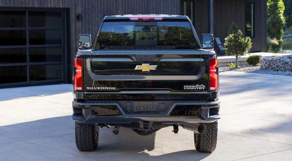 A black 2024 Chevy Silverado 2500 HD High Country is shown from the rear.