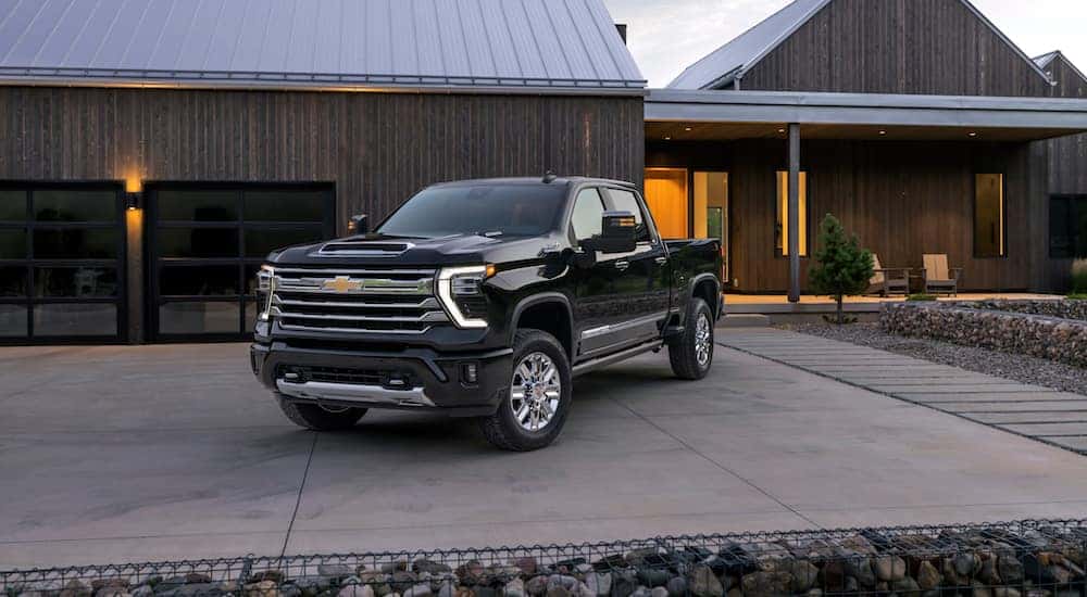 A black 2024 Chevy Silverado 2500 High Country is shown from the front at an angle.