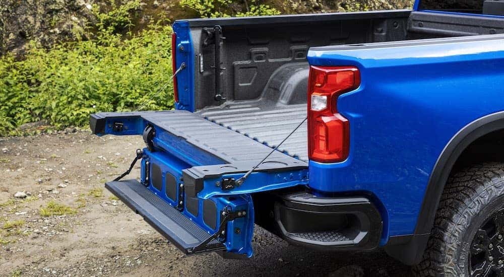 A blue 2024 Chevy Silverado 1500 ZR2 is shown with the tailgate down.