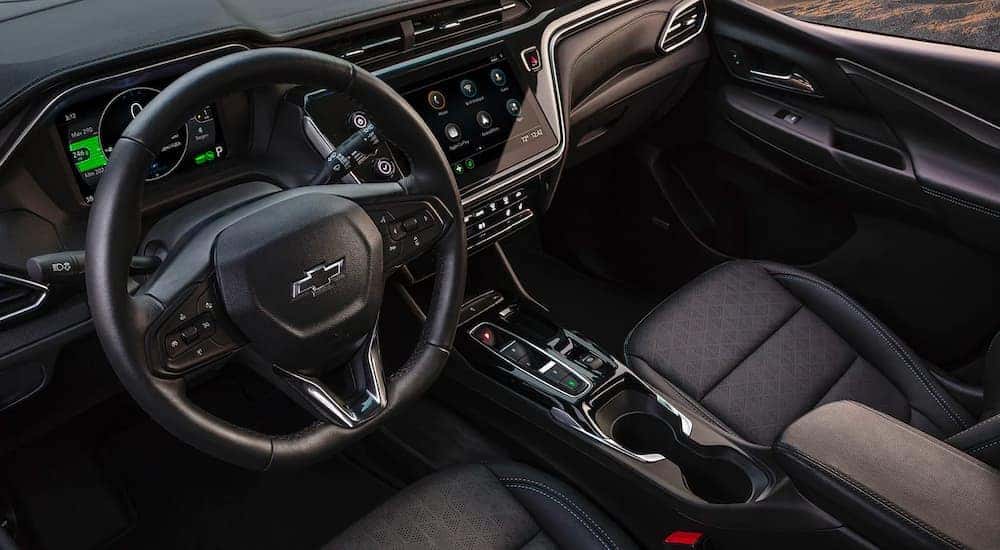 The black interior and front seats are shown in a 2022 Chevy Bolt EV.