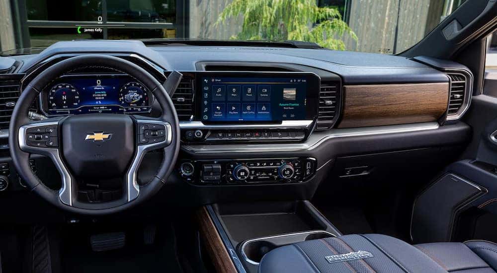 Black upholstery and wood accents in the cabin of a 2024 Chevy Silverado 2500 High Country.