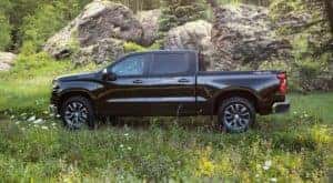 A black 2022 chevy Silverado is shown from the side parked in a field after leaving a Chevy dealer in KY.