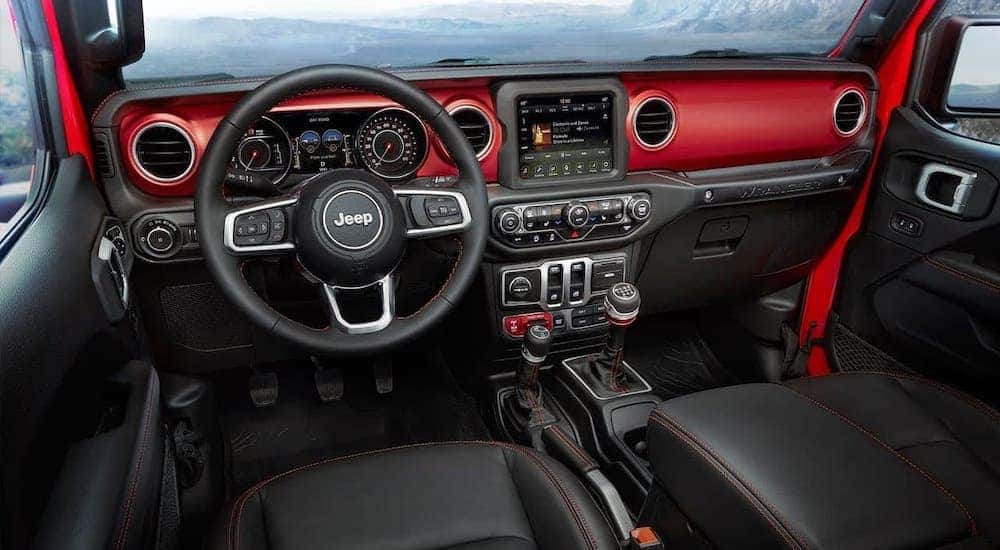 The red interior of a 2019 used Jeep Wrangler is shown.