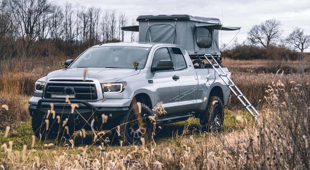 A truck from a Lexington used truck dealership is being used to hold a tent.