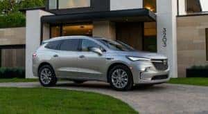 A silver 2022 Buick Enclave Avenir is shown parked in a driveway.