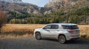 A silver 2022 Chevy Traverse Premium is parked near mountains.