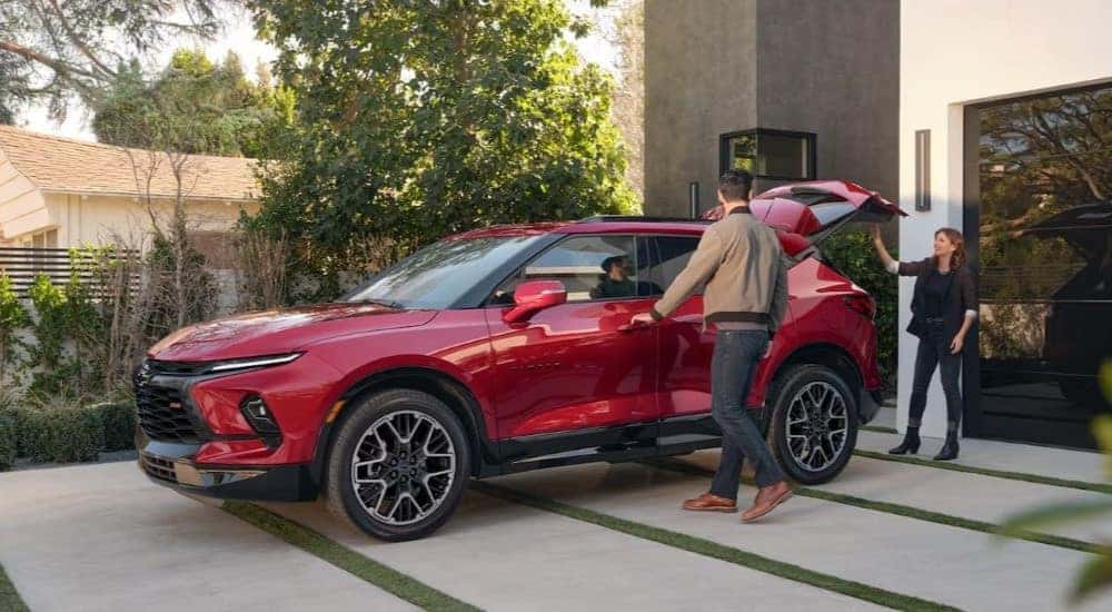 A red 2021 Chevy Blazer RS is shown parked on a driveway after leaving a used Chevy dealership.