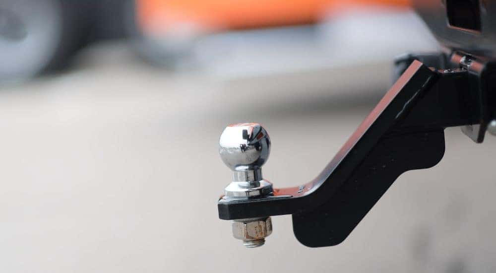 A close up shows a chrome trailer hitch.