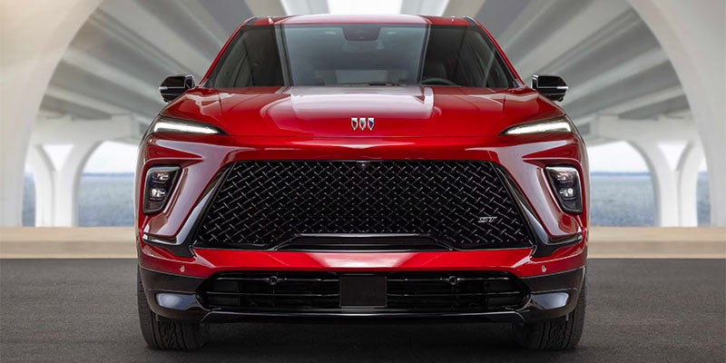 Red Buick Enclave front angle view of the hood, headlights, and windows