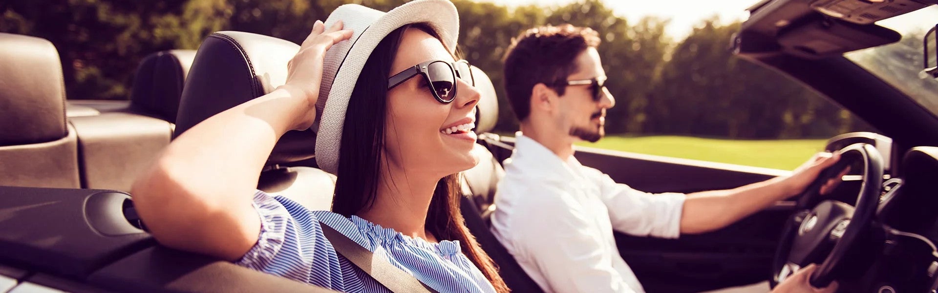 man and woman in convertible